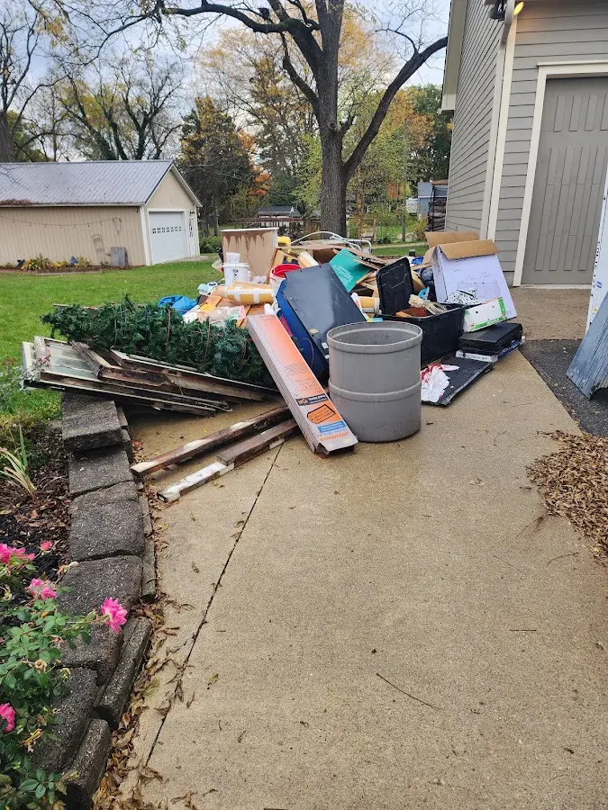 Dumpster being loaded with debris for Estate Cleanout Dumpster Rental in Evergreen